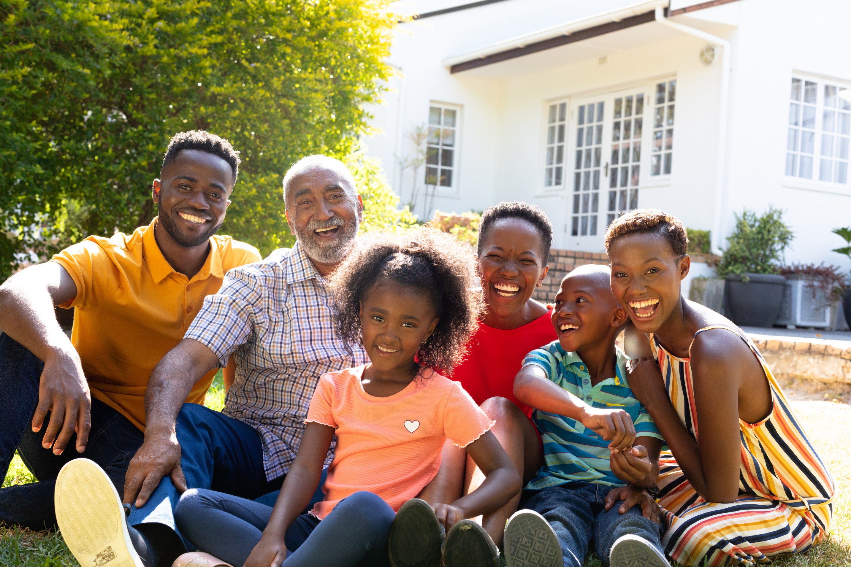 Smiling multi-generational family on a sunny porch